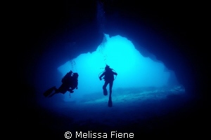 Image of divers in a cave, Vava'u Tonga. by Melissa Fiene 